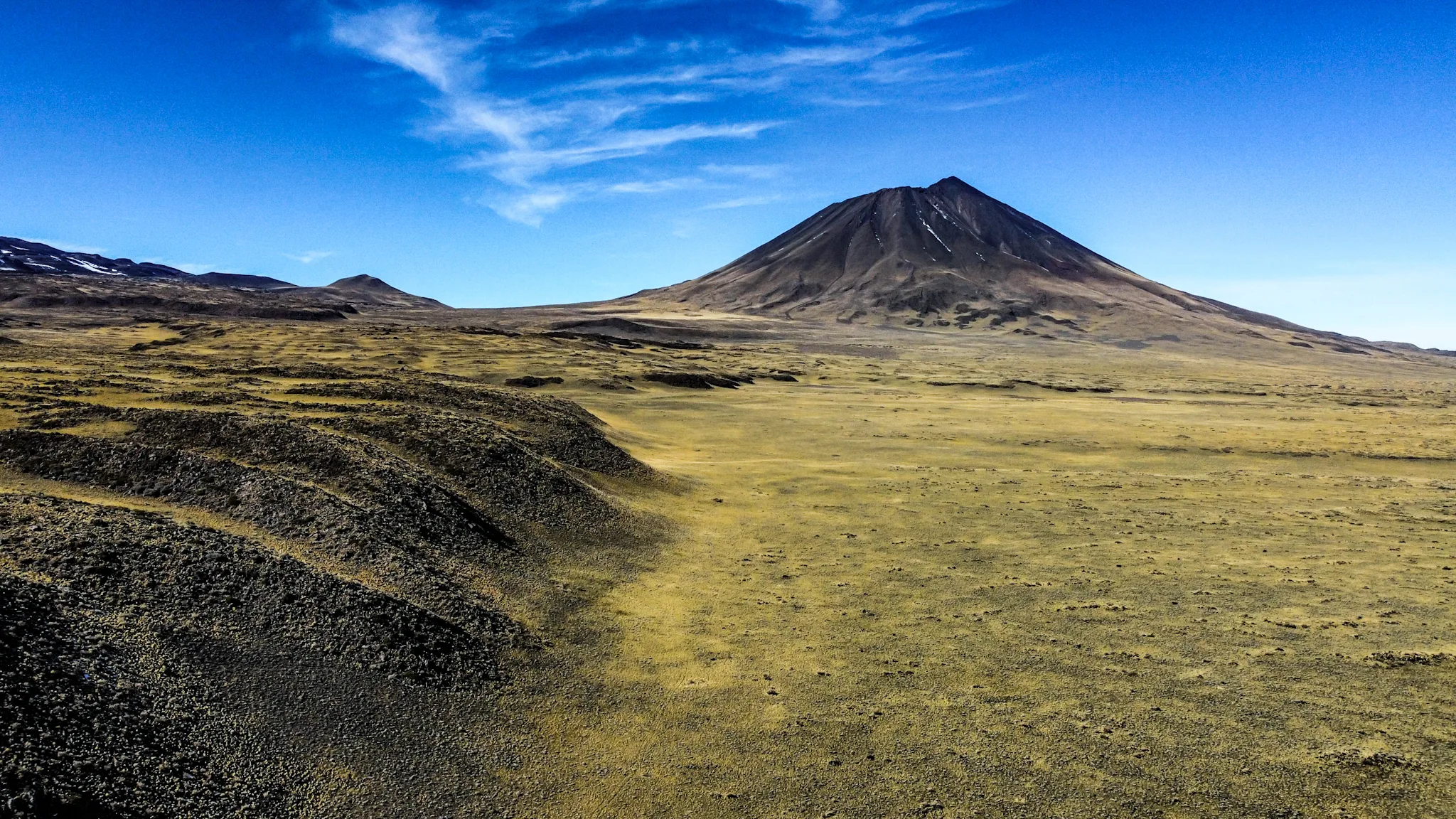 Group of tourists with guide in the volcanic landscape of Malargüe